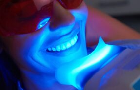 An image depicting the teeth whitening process, highlighting the benefits and potential side effects for a brighter smile.